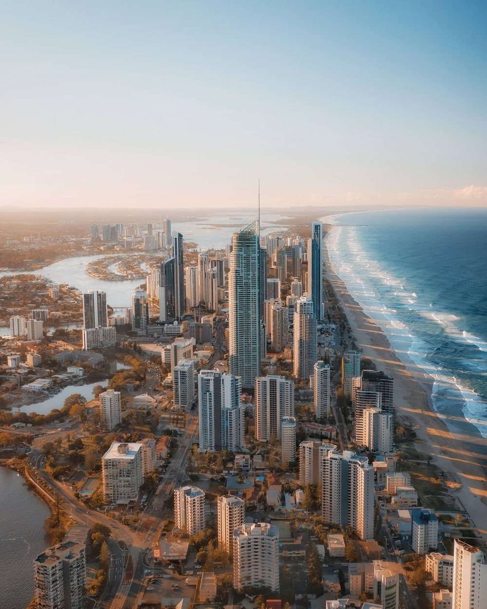Surfers Paradise from the air at golden hour, between the river and the beach
