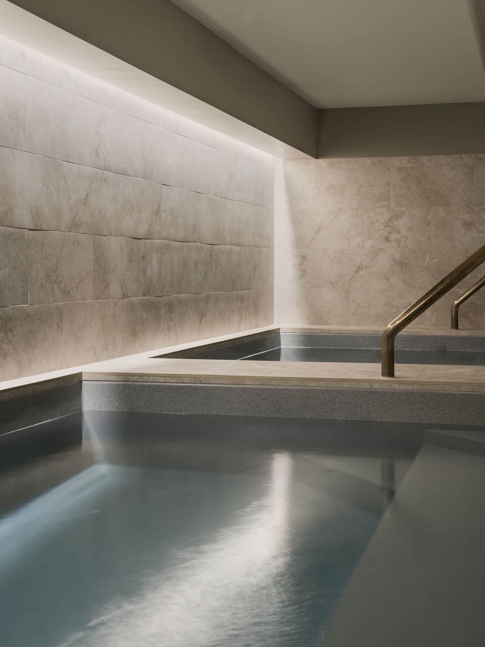 A still, softly lit stone plunge pool at Native State