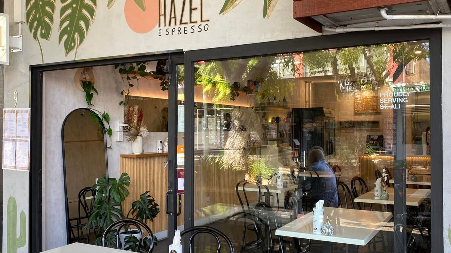 The Hazel Espresso shopfront, with plants and an arched window