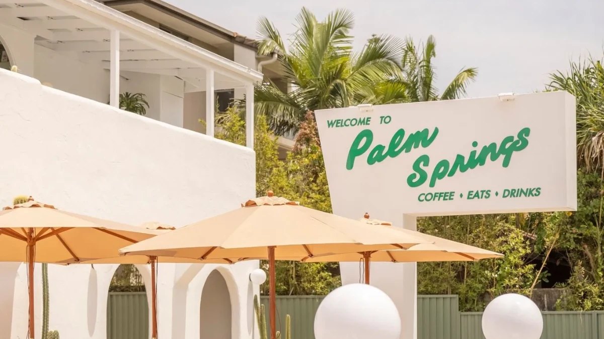 The Palm Springs sign and orange umbrellas outside the cafe