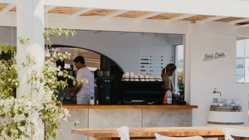 The white espresso bar at Next Door Espresso, open to the street
