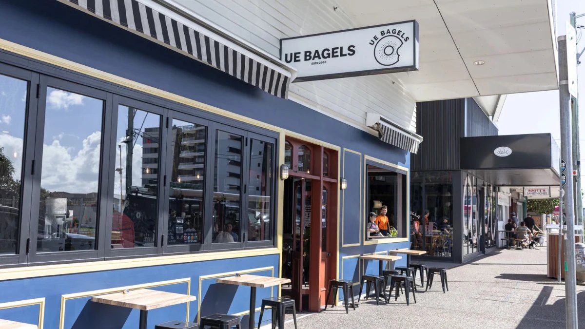 The blue Ue Bagels shopfront with its round sign
