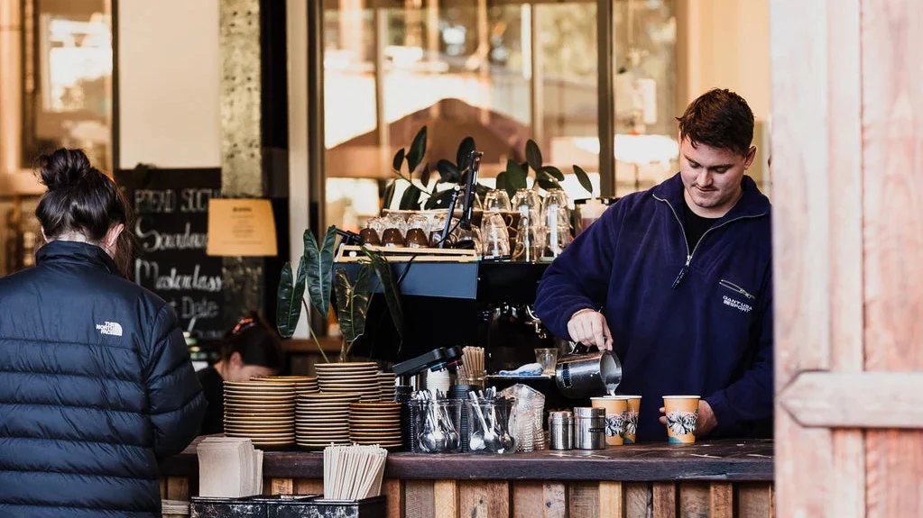 A barista pouring coffee at Bread Social