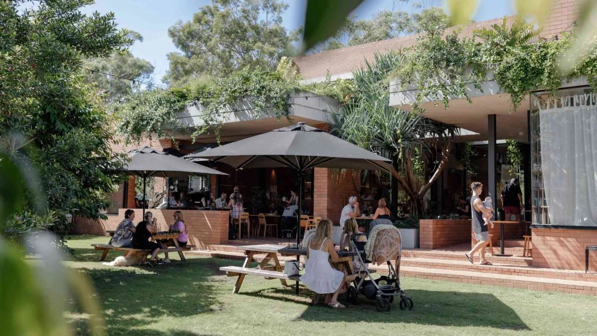 Umbrellas and picnic tables on the lawn at Stable Coffee Kitchen