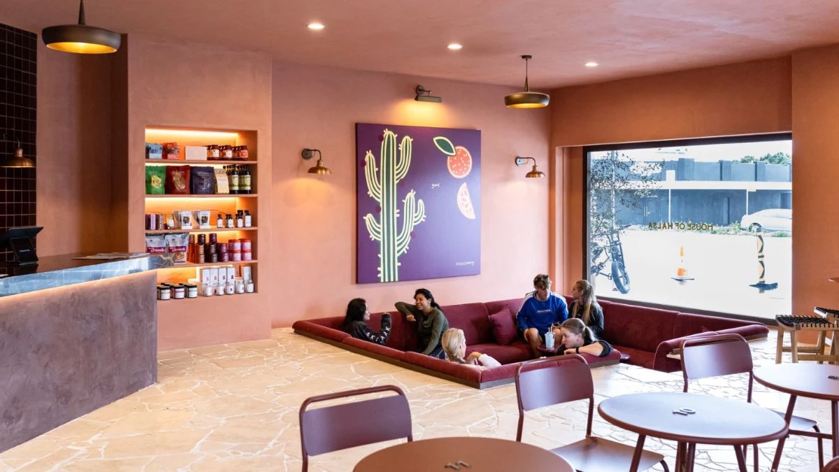 House of Hälsa's pink lounge, with a sunken couch and a cactus print