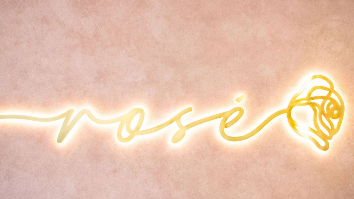 Rosé Gelateria's neon sign on a pink wall