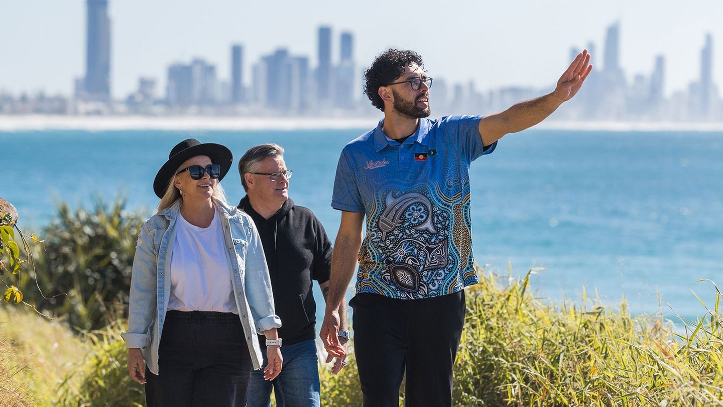 A Jellurgal guide pointing out the coast to visitors on the Burleigh headland