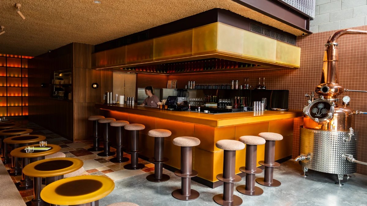 The copper still and bar stools at Burly Bar