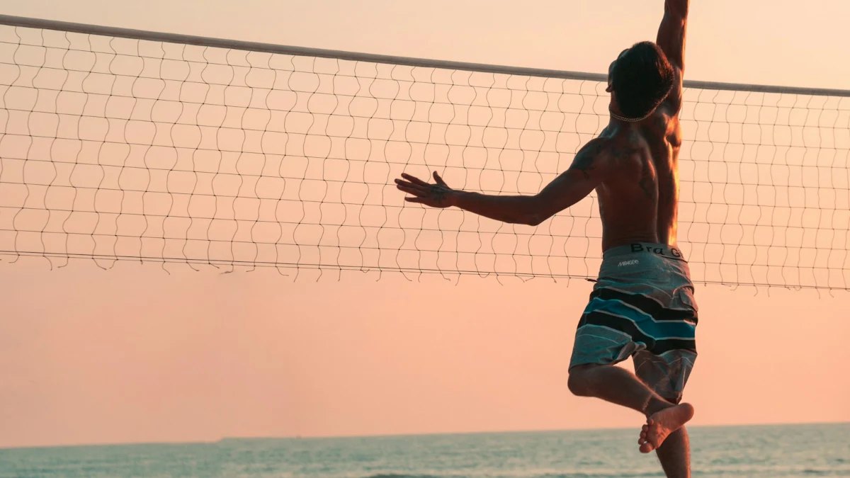 A beach volleyball player at the net