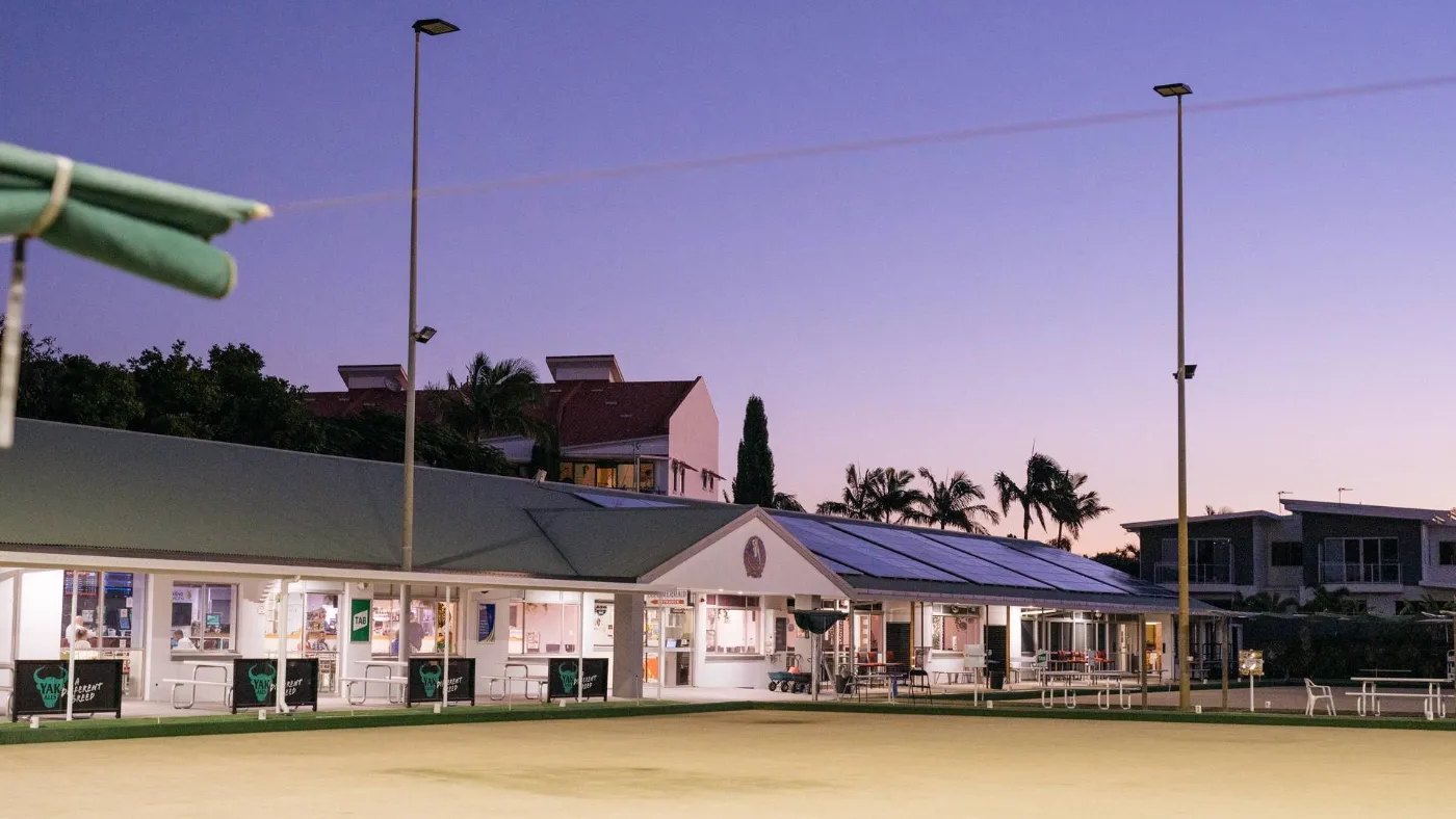 The bowling green and clubhouse at Club Mermaid at dusk