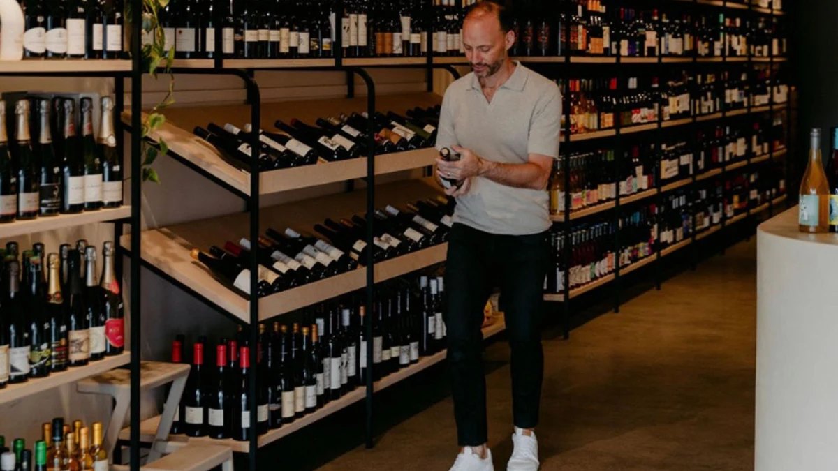 A customer browsing the shelves at Somm Wine Store