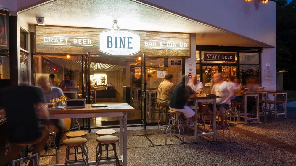 Tables outside Bine Bar & Dining at dusk