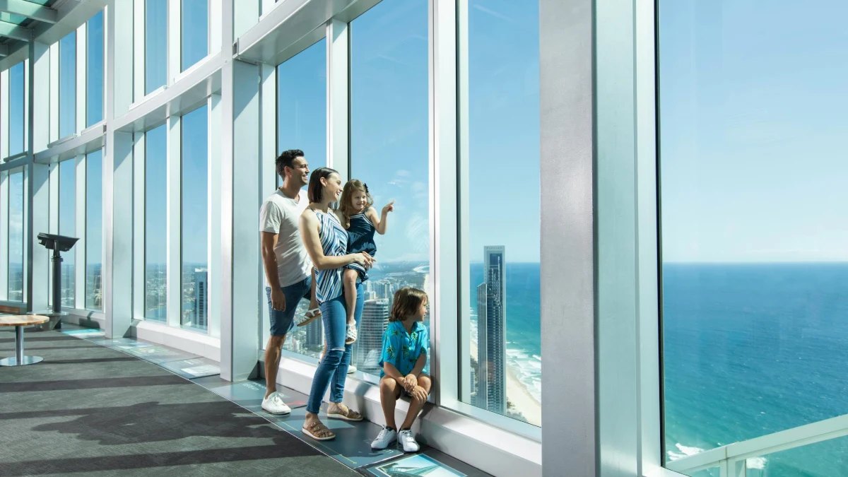 A family at the floor-to-ceiling windows of the SkyPoint observation deck