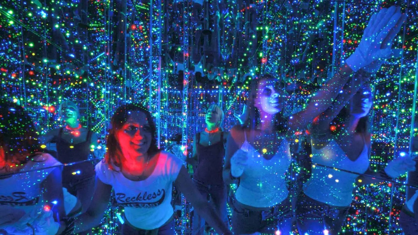Visitors in Infinity's room of coloured lights