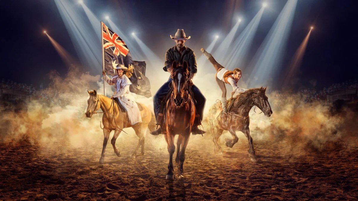 Riders and horses performing in the Outback Spectacular arena
