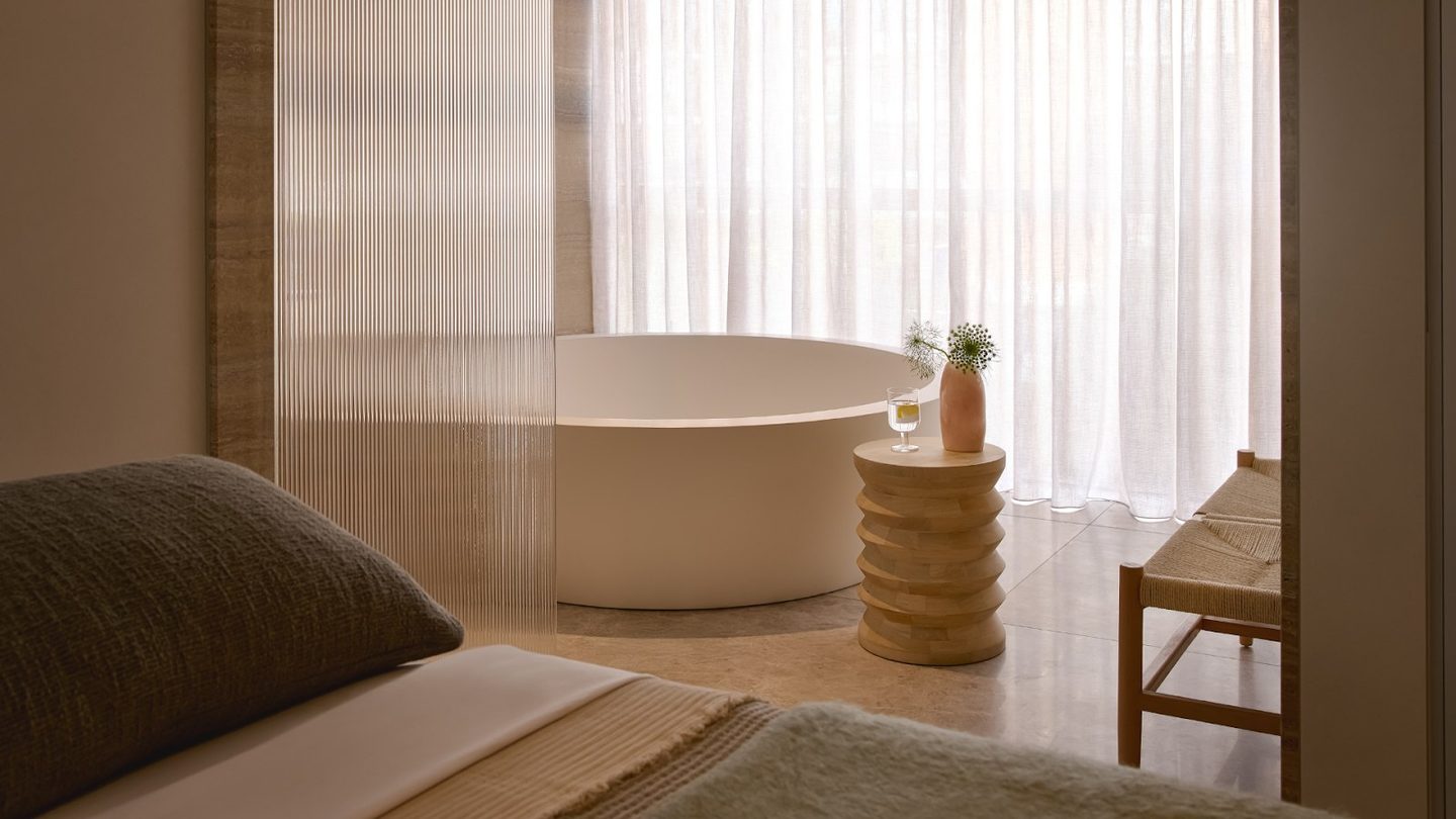 A freestanding bath in a softly lit treatment room at CIEL Spa