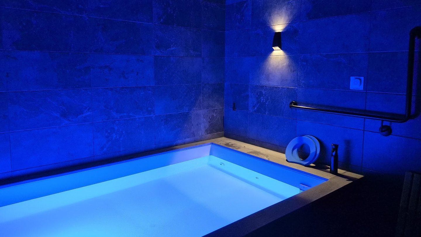 A float pool lit blue at City Cave Robina