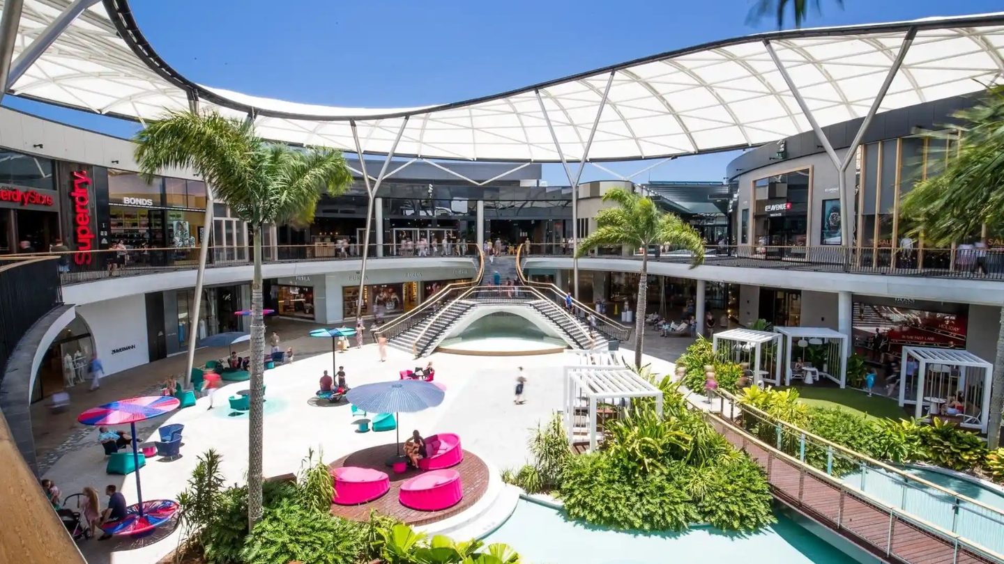 Pacific Fair's open-air Resort precinct, with palms, pink seats and water features