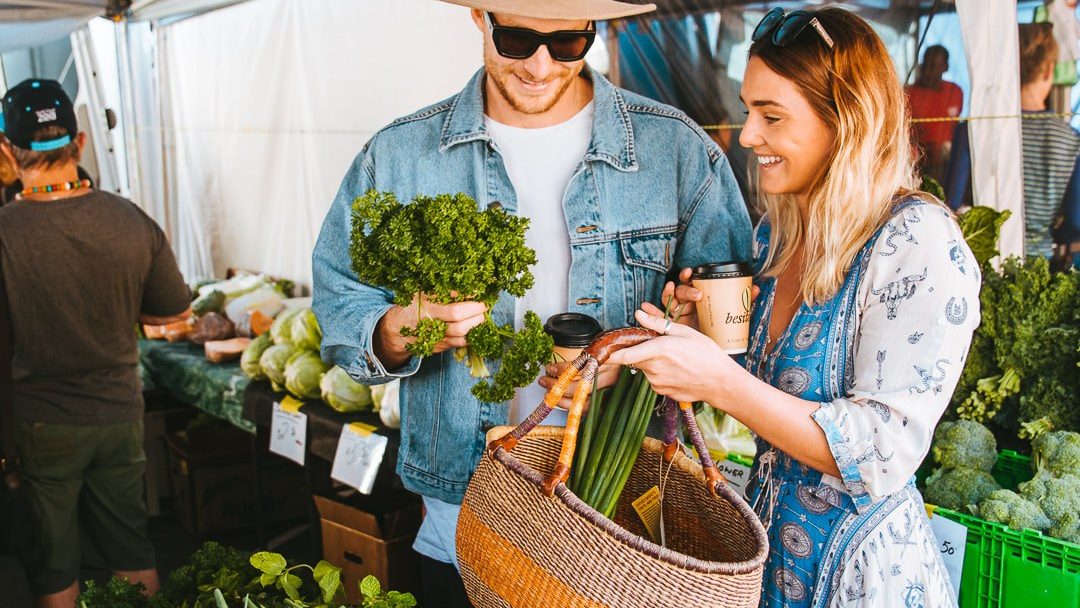 Shoppers choosing fresh produce at Burleigh Market