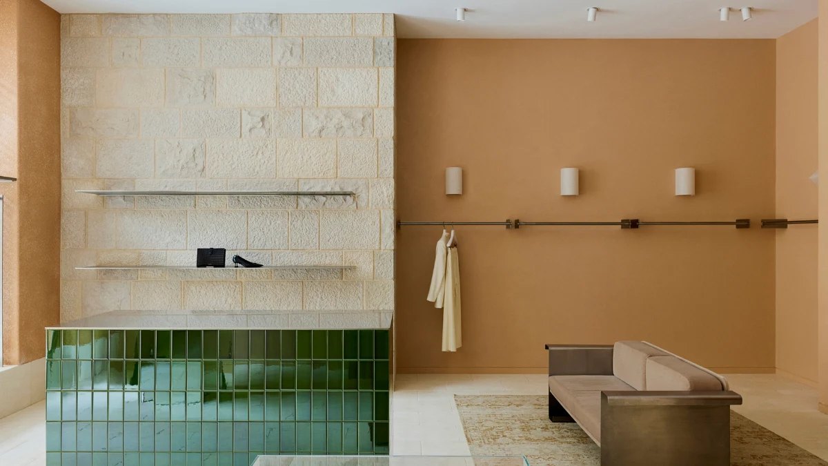 Stone walls and a bench inside the Camilla and Marc boutique