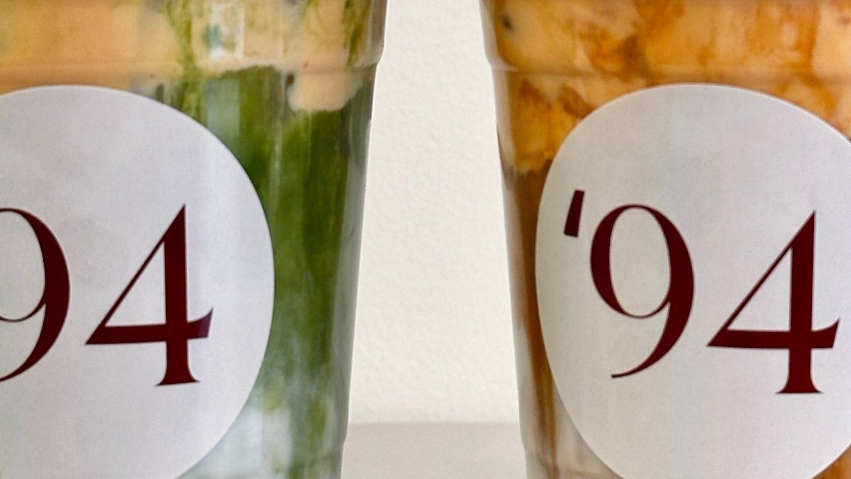 Two '94 matcha drinks in branded cups