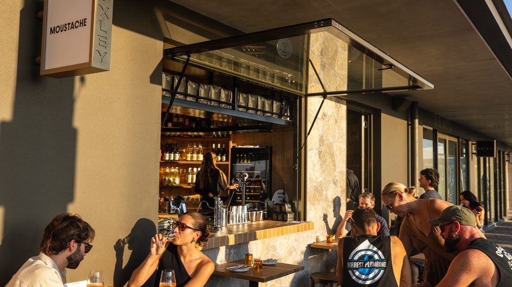 Diners at the outdoor tables in front of the bar at Moustache
