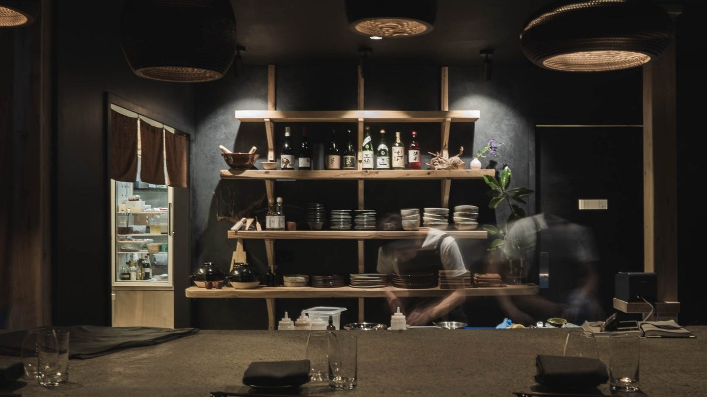 The dark timber counter and shelves at Anekawa