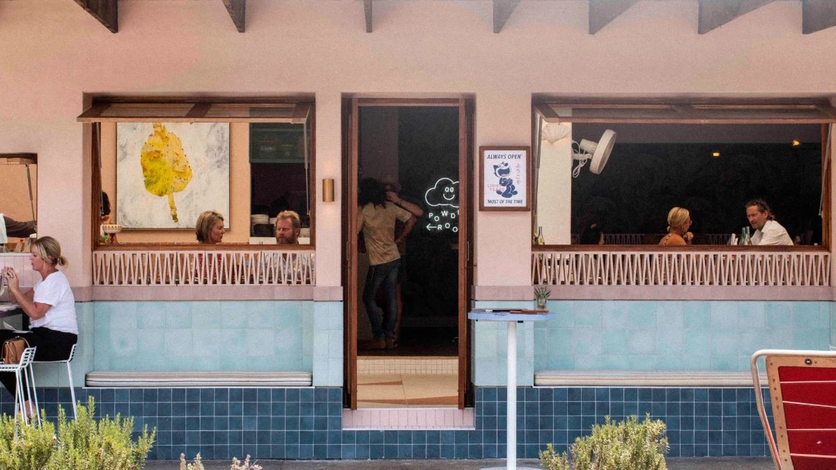 The pink and blue front of Light Years, with diners at the open windows