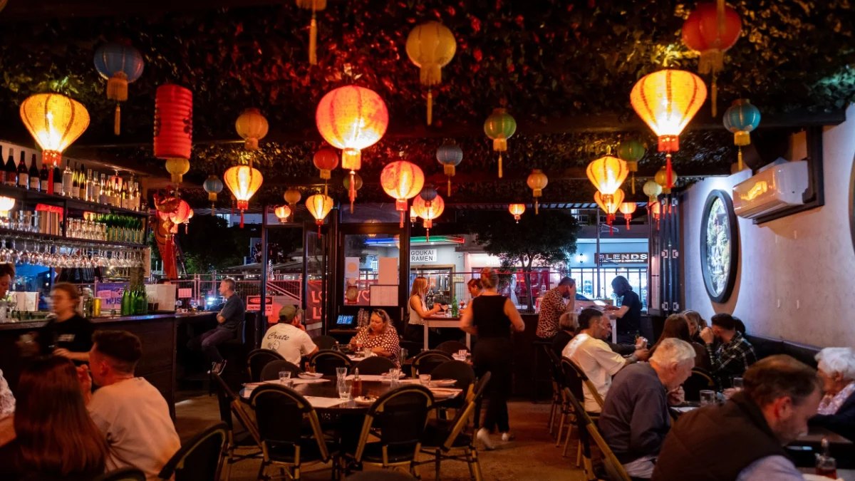 Diners under strings of paper lanterns at Mr Hizola's