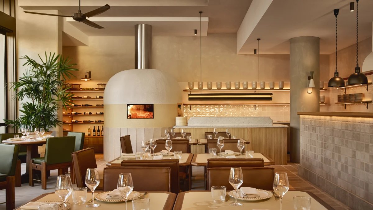 Haven's dining room, with a pale pizza oven and timber tables