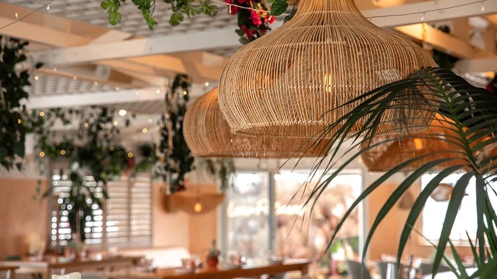 Woven pendant lights and palms in the Las Palmas dining room