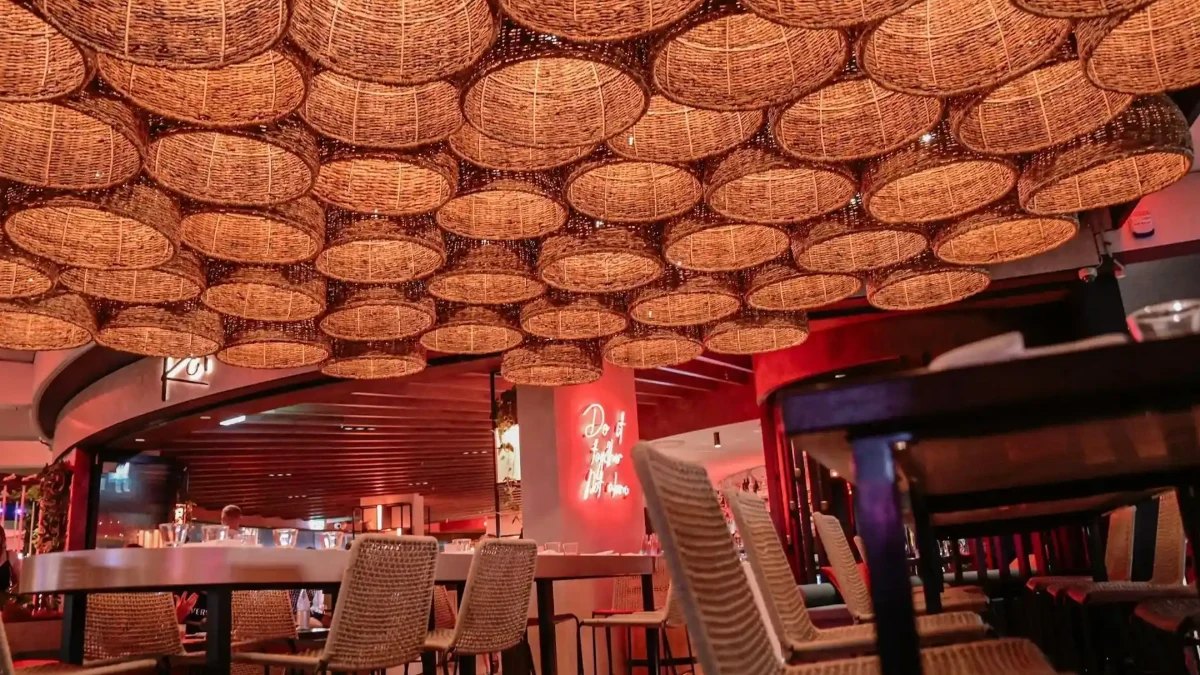Koi's dining room under a ceiling of woven lampshades