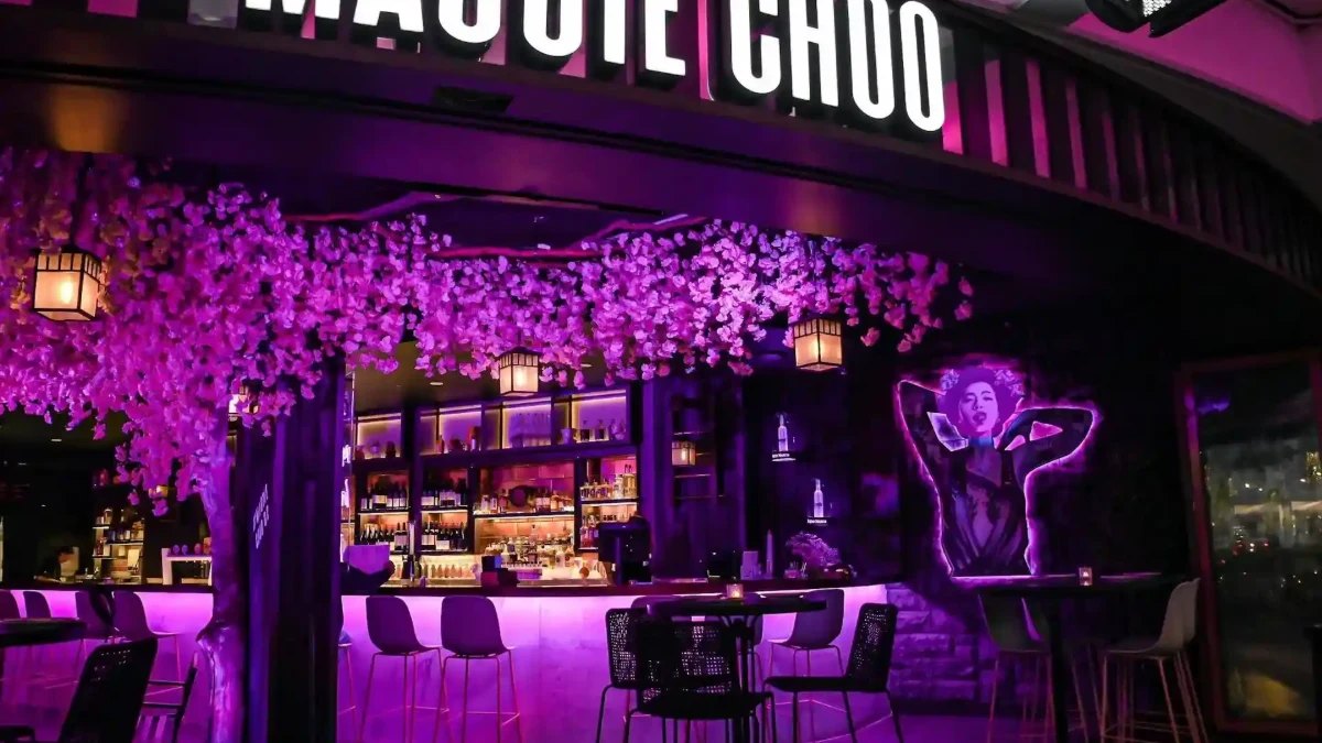 Purple light and a blossom tree over the bar at Maggie Choo