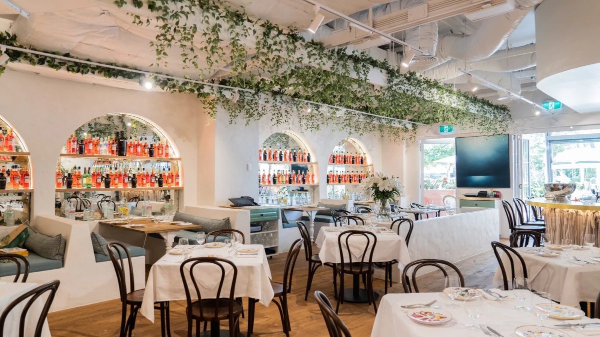 Sofia's white dining room, with arched shelves and hanging greenery