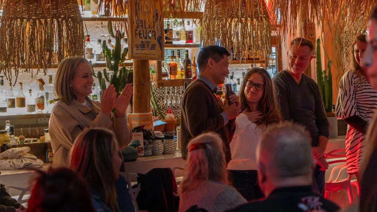 Guests smiling and clapping inside Nude Amigos
