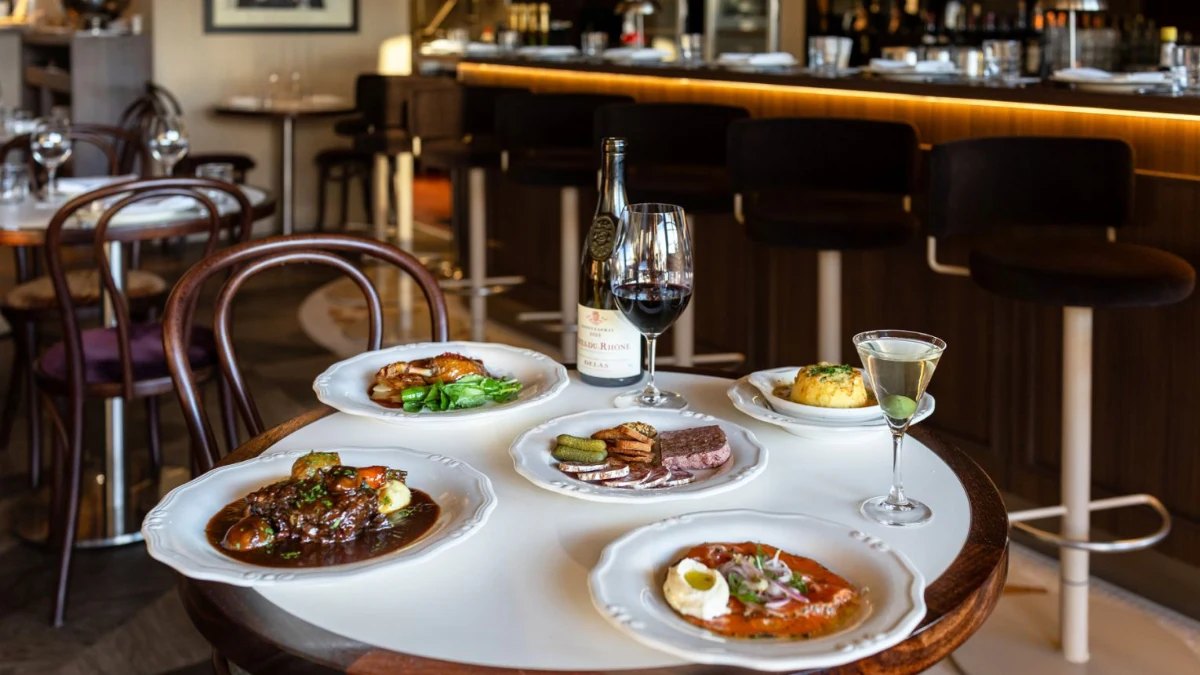 French dishes and a martini on a table at Bistro Margaux