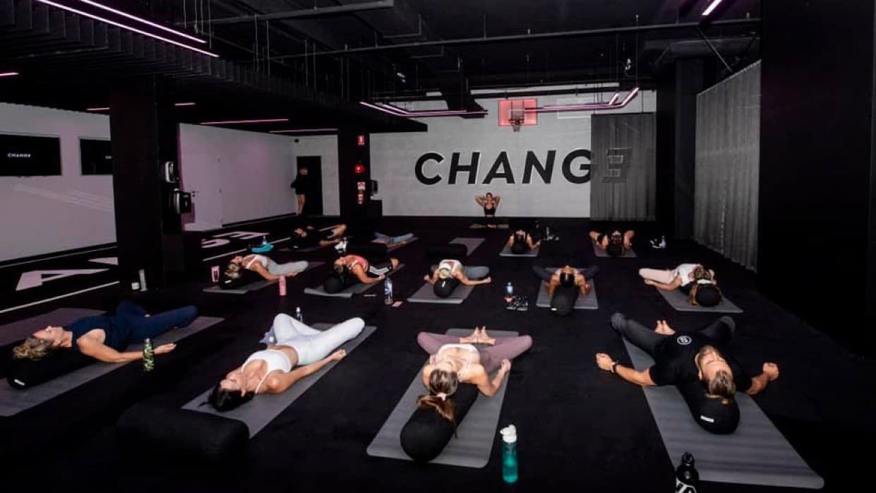 A class lying on mats in the dark studio at CHANGE Broadbeach