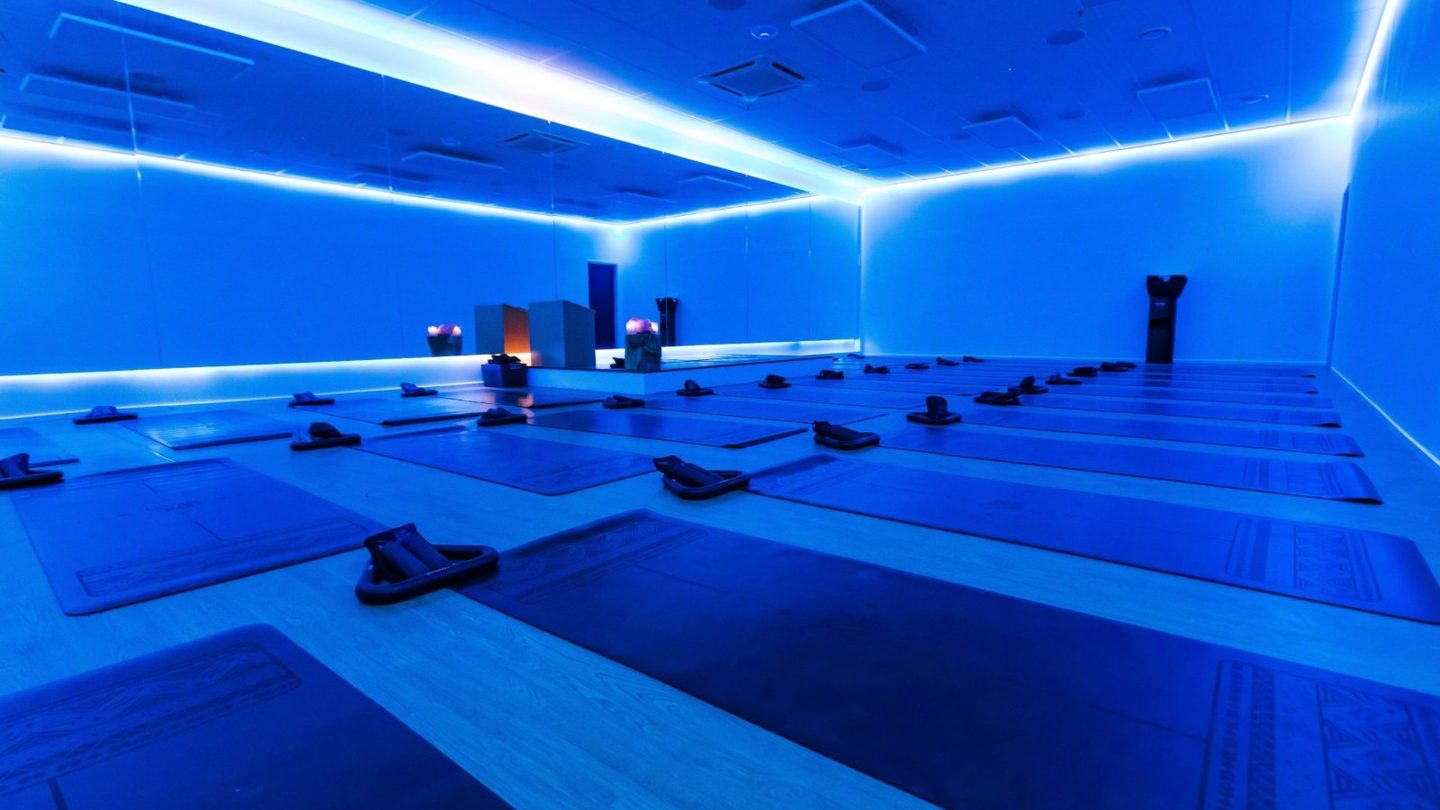 The blue-lit hot studio at Therapy Fitness