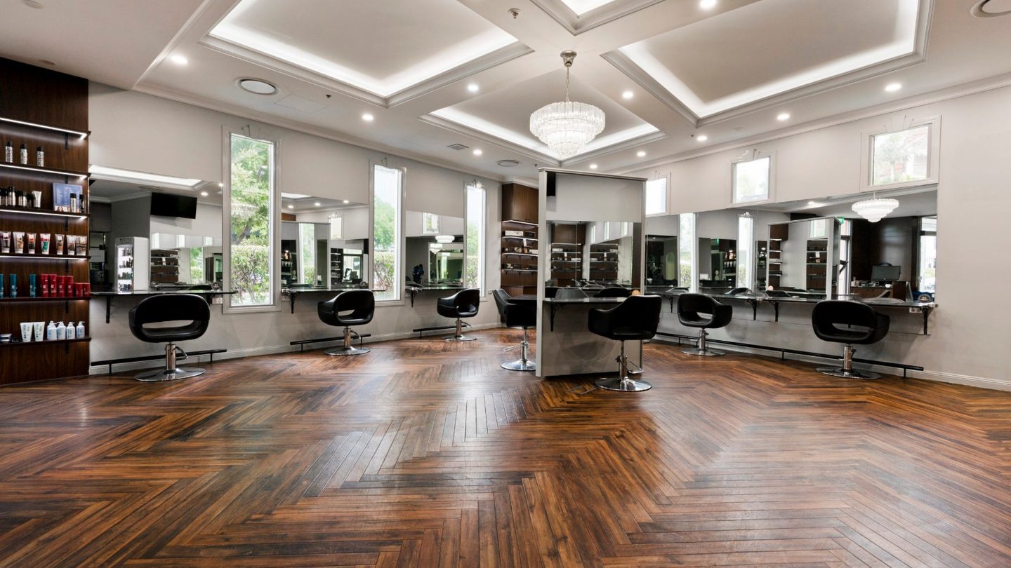 Styling stations under a chandelier at TONI&GUY Broadbeach