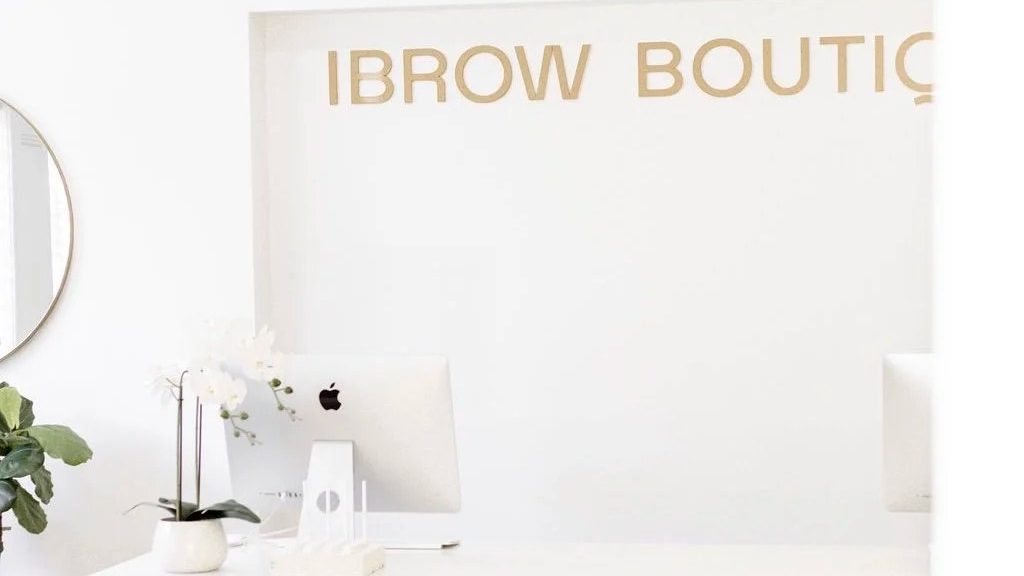 The reception desk and sign at iBrow Boutique